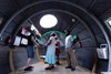 Stephen Turner with visitors in the Exbury Egg, 2019, Thamesmead, London